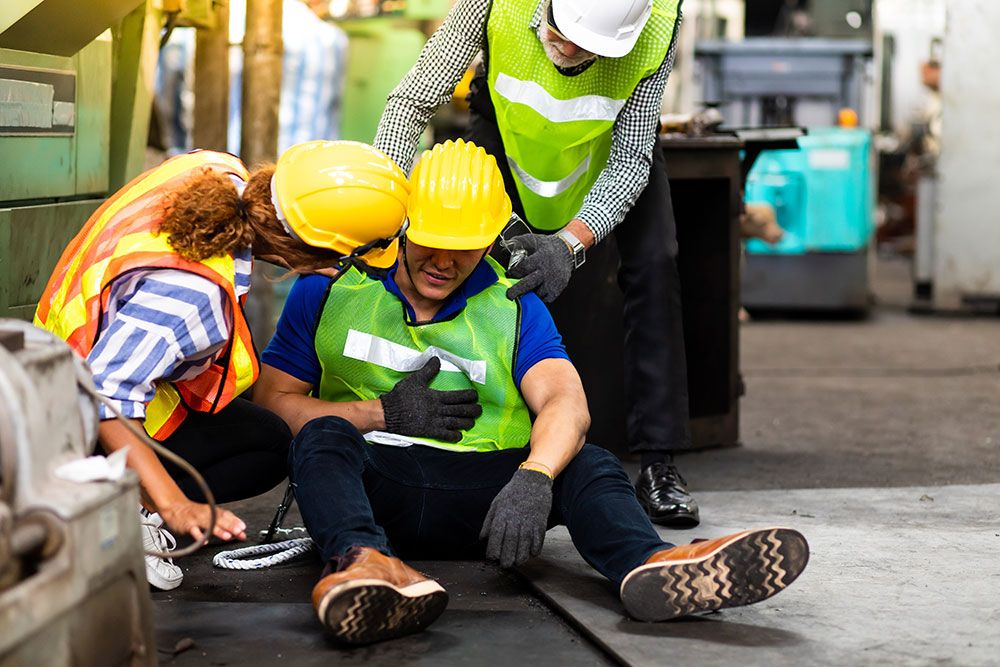 A man on a construction site falls down in the workplace in Greenville South Carolina and needs help from his staff members. He will bring up the case later with a personal injury attorney