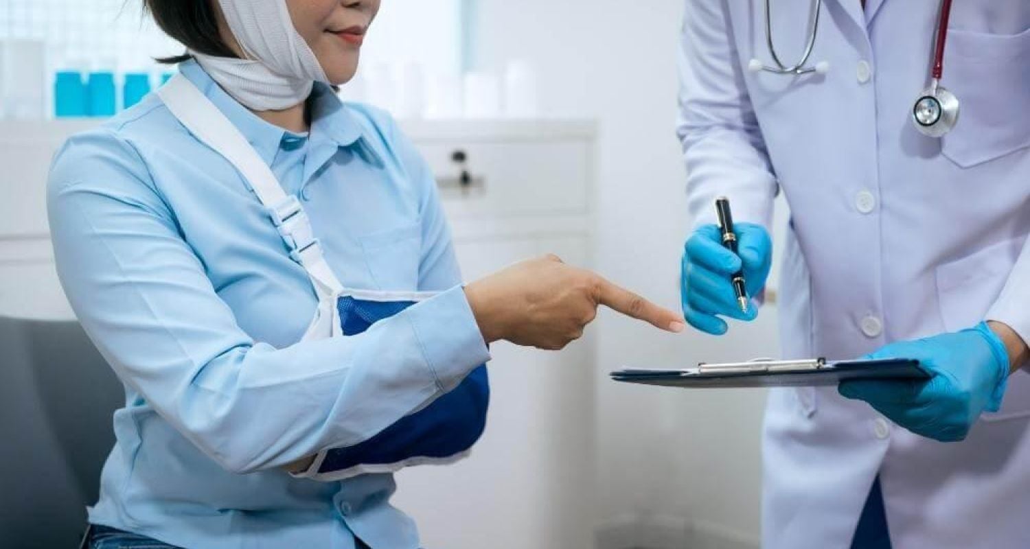 Woman holding a clipboard in a doctor's