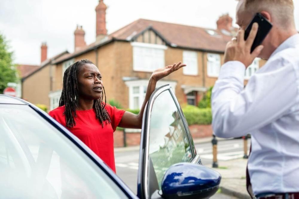 Woman on a cell phone next to a man,