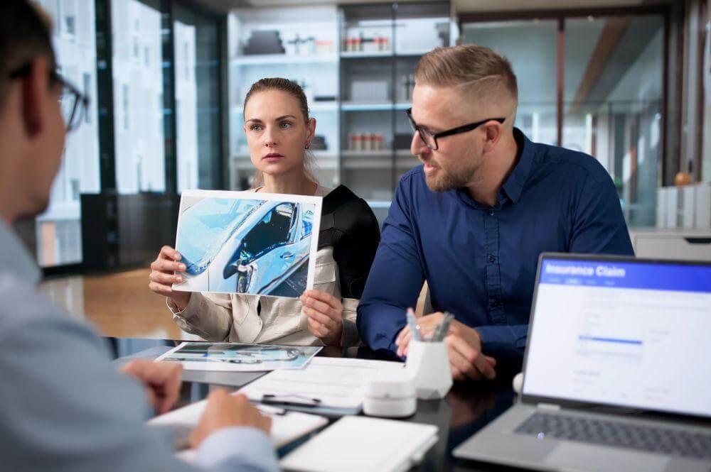 Couple at laptop researching rear-end collision fault in
